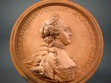 an image of a bronze medallion with a woman ' s profile