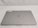 a silver apple laptop sitting on a white surface