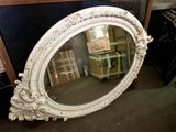a mirror that is sitting on the floor in front of a table