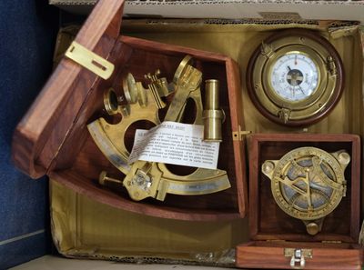 a box with a clock, compass, and other items in it