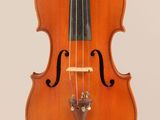 an old violin with a bow hanging from it ' s back