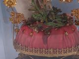 a glass case with a statue of a person holding a flower