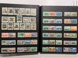 an open book with a bunch of different stamps on it