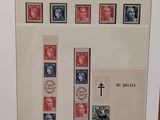 a picture of a framed picture with stamps and a cross