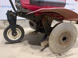 a red lawn mower that is sitting on the ground