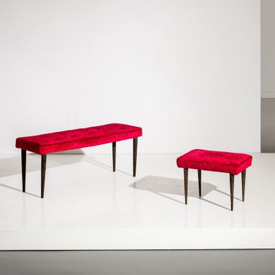 a red bench and a red ottoman in a white room