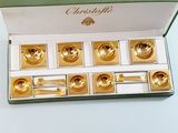 a box that has a set of gold tea cups in it
