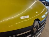 a close up of a yellow truck with a sticker on it