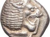 a silver coin with a face on it on a white background