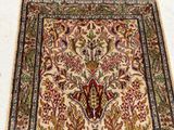 an antique persian rug with a floral design on a white background