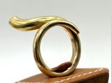 a gold ring sitting on top of a wooden block