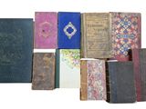 many old books that are stacked together on a white surface