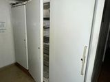a white refrigerator in a room with a door open