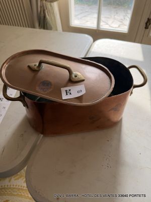 a large copper pot on a table with a price tag on it