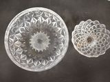 a glass bowl and a glass plate on a table