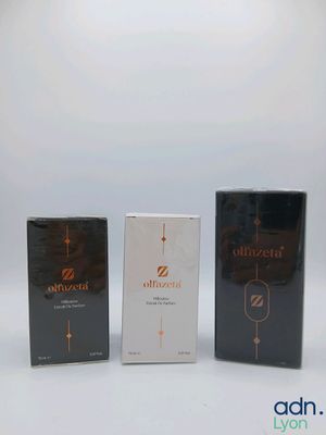 three boxes of different types of perfume sitting next to each other