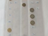 five different coins in a clear plastic bag