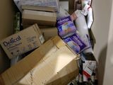 a pile of boxes and other items in the corner of a room