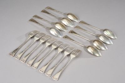 six silver spoons and six spoons on a white surface