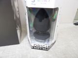 a black egg shaped object in a box on a table