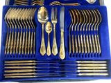 a blue box with silverware in it on a white surface