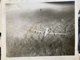 an old photo of a plane flying in the sky