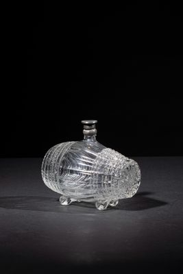 an image of a glass bottle on a table with a black background
