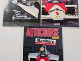 three books on a white surface with a picture of a man driving a racing car
