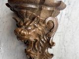 a wall sconce that has a lion head on it