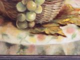 a painting of a basket of grapes on a table