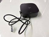 a small black device on a table with a cord