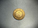 a close up of a gold coin on a table