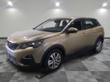 the beige car is parked on a checkered floor in the garage
