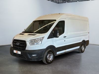 the white van is parked in the large room of the building
