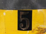 a close up of a yellow fire hydrant with a number 5 on it