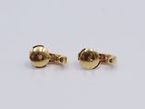 two pairs of gold plated cufflinks on a white surface