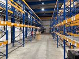 a large warehouse filled with lots of shelves and pallets