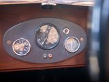 a close up of a dashboard with a clock and gauges