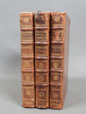a set of three old books sitting on top of each other
