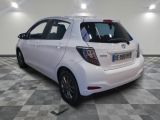 a white car that is parked in a room