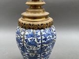 an image of a blue and white vase with a gold lid