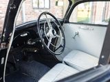 a black and white car with a steering wheel and dashboard