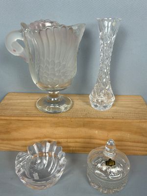 trois vases en verre posés les uns à côté des autres sur une étagère en bois