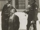a black and white photo of a group of men on the street