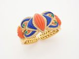 a close up of a ring with an orange and blue design
