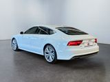 the rear end of a white audi sedan parked in a white room
