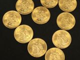 a close up of a heart made of gold coins on a black surface