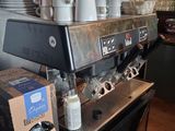 a coffee machine sitting on a table in a coffee shop