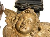 a statue of an angel next to a box and a clock
