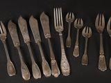 a lot of forks and spoons sitting on a table